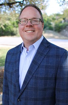 WCID No. 17 Chief Operating Officer and General Manager smiling outdoors in business attire.