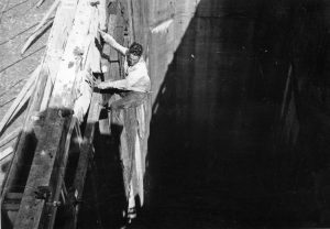 Black and white photo of a Mansfield Dam construction worker in 1940, scaling the dam's structure during its construction. Photo rights LCRA.