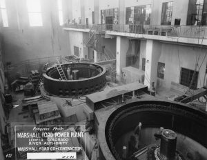 Black and white photograph of the Marshall Ford Power Plant in 1940, showcasing the structure and surrounding area during its early years. Photo rights LCRA.