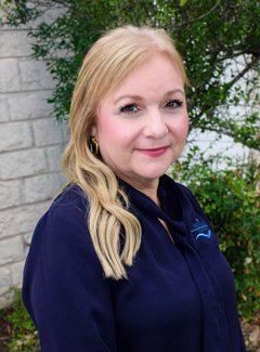 WCID No. 17 Human Resources Manager smiling, dressed in professional business attire.